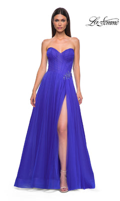 A woman models the La Femme 32789 Strapless Long Prom Ball Gown in royal blue, styled with a sweetheart bodice, high slit, and rhinestone floral waist detail. The La Femme logo is displayed in the top right corner.
