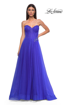 A woman in the La Femme 32789 Strapless Long Prom Ball Gown, royal blue, with a sweetheart bodice and rhinestone floral waist detail.