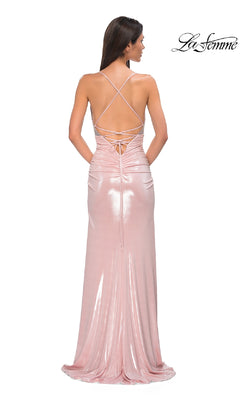 Woman wearing a light pink, floor-length Strappy Long Jersey Prom Dress: La Femme 32793 with a ruched open back and crisscross straps, standing with her back to the camera. "La Femme" logo appears in the top right corner.