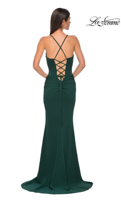 A woman is seen from behind in the La Femme 32802 Lace-Up Open-Back Long Prom Dress, featuring a dark green hue, crisscross lace-up back, and a slight train.