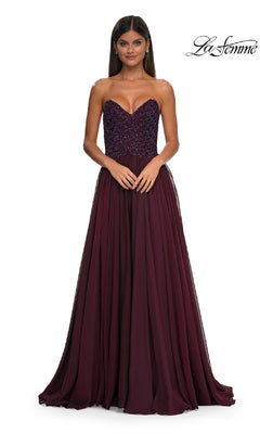 A woman models the Strapless Long A-Line Prom Dress: La Femme 32804 with a fitted, embellished bodice and flowing skirt against a white background. The "La Femme" logo is displayed in the top right corner.