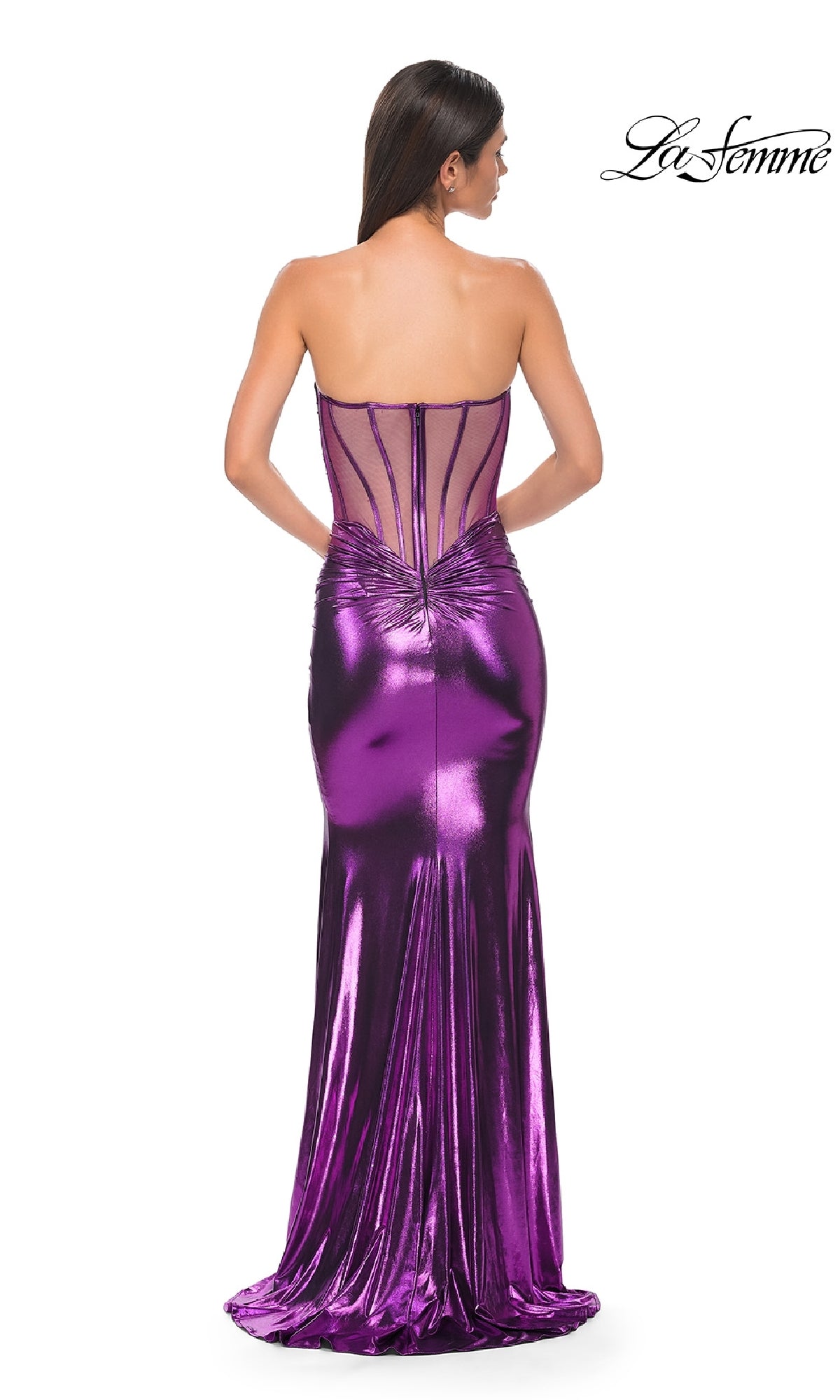 A woman models the La Femme 32806 Strapless Long Metallic Prom Dress in purple, featuring a sheer structured back and fitted silhouette, as she faces away from the camera. The La Femme logo appears in the top right corner.