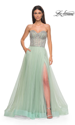 A woman poses against a plain white background wearing the La Femme 32811 Strapless Long Prom Ball Gown in mint green, featuring a beaded sweetheart corset bodice and high slit.