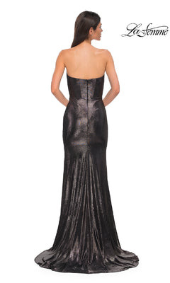 A woman faces away from the camera in the La Femme 32828, a strapless long metallic prom dress with a fitted bodice and slight train. The La Femme logo is visible in the upper right corner.