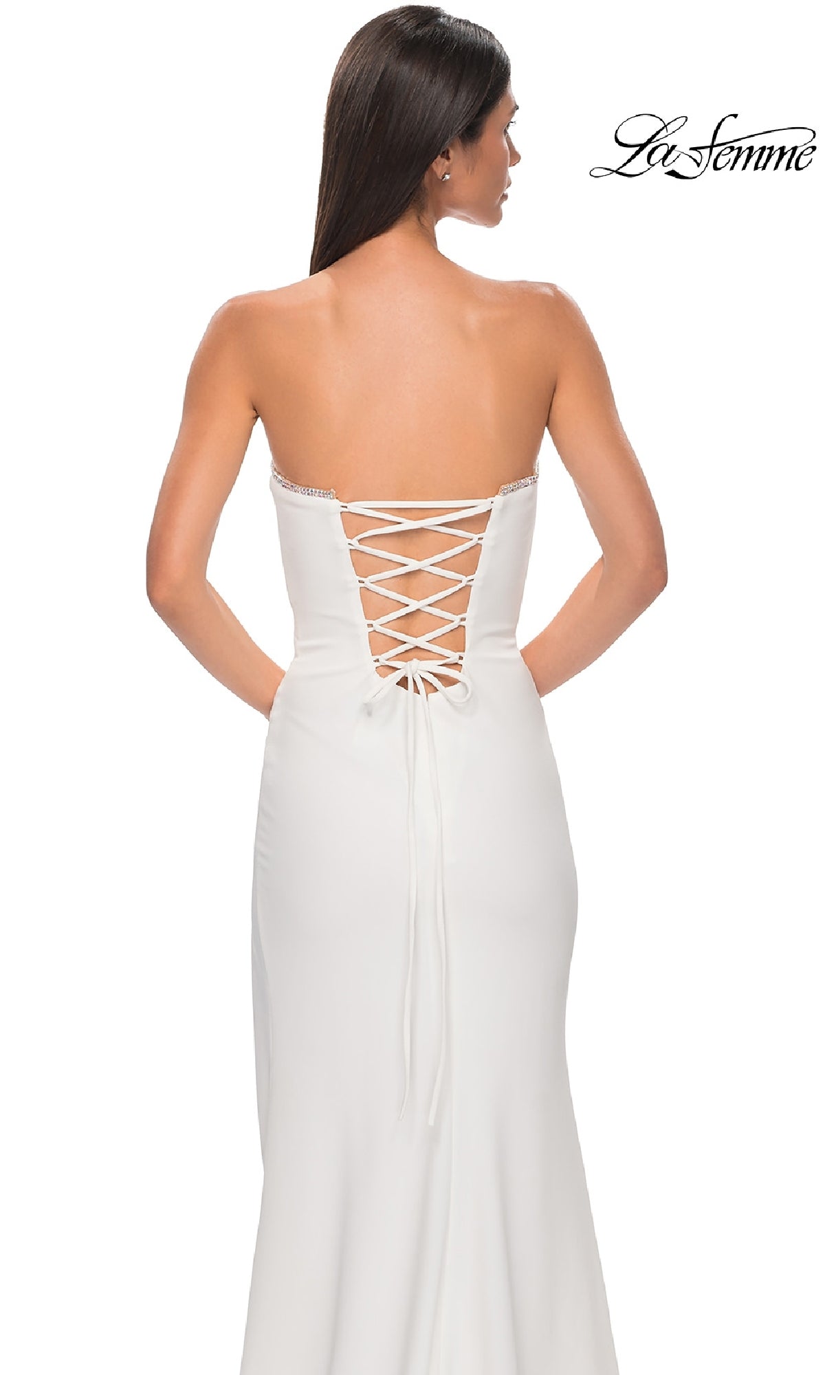A woman stands against a white background in the La Femme 32829 Lace-Up Strapless Long Prom Dress, showcasing its elegant style and sophisticated lace-up back detail.