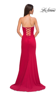 A woman models the Lace-Up Strapless Long Prom Dress: La Femme 32829, featuring a lace-up back and floor-length train, standing against a white background with the "La Femme" logo in the top right corner.