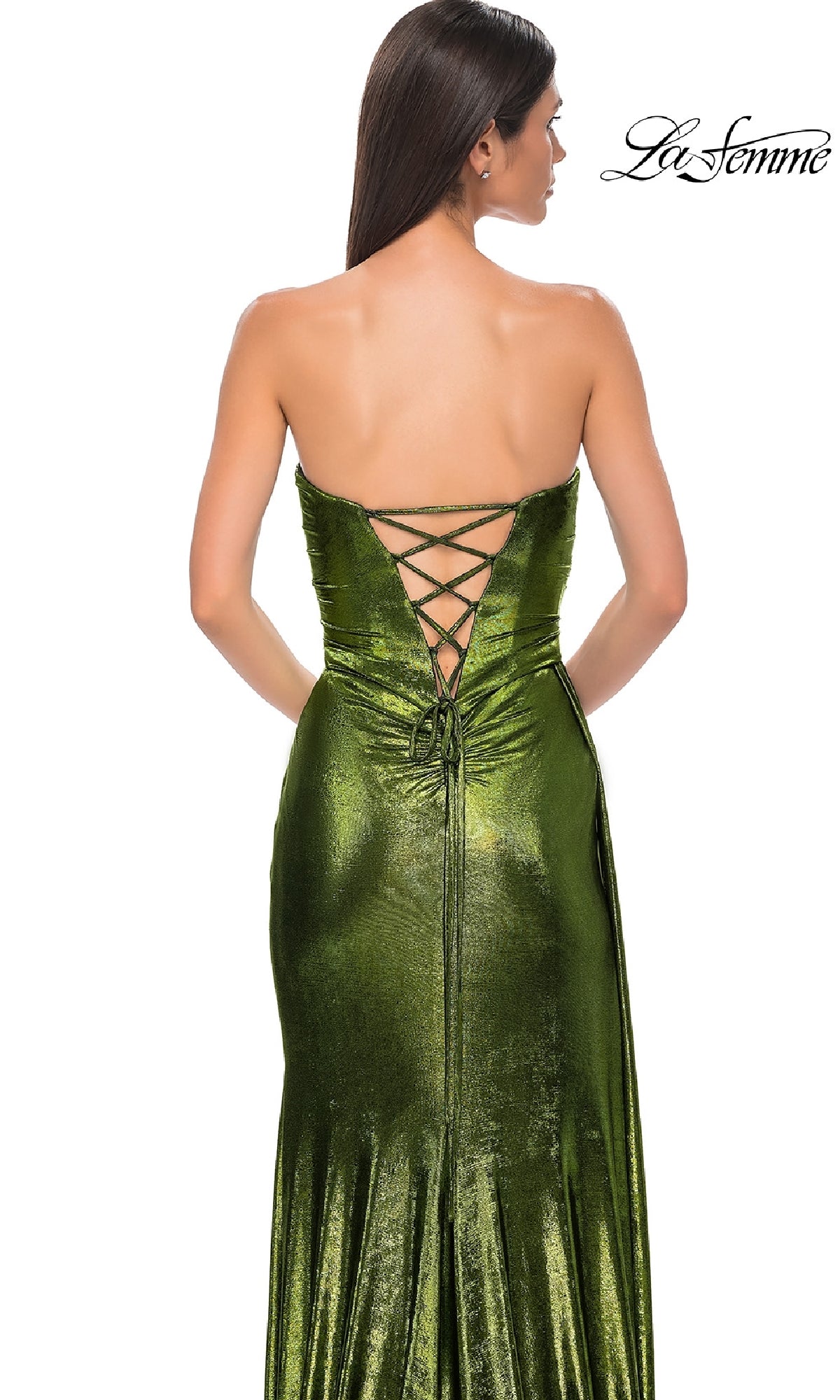 A woman wears the Strapless Long Metallic Prom Dress: La Femme 32830, featuring a metallic finish and lace-up back, standing with her back to the camera. The La Femme logo appears in the top right corner.