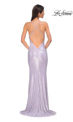 Woman wearing a shimmery lavender Metallic-Jersey Long Prom Dress (La Femme 32835) with a backless crisscross-strap design, facing away; "La Femme" logo displayed in the top right corner.