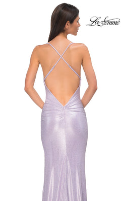 A woman poses with her back to the camera in a fitted, backless Metallic-Jersey Long Prom Dress (La Femme 32835). The lilac gown features crisscross straps and shimmers elegantly against a plain white background.