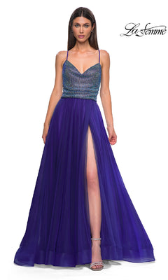 A woman stands against a white background wearing the La Femme 32838, a cowl-neck, sleeveless, floor-length indigo prom dress featuring a beaded bodice and high slit.
