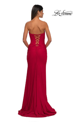 A woman, her back to the camera, showcases the elegant floor-length skirt of the Strapless Sweetheart Prom Gown: La Femme 32843, featuring a fitted bodice, corset back, and strapless sweetheart neckline.