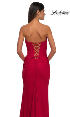 A woman models the Strapless Sweetheart Prom Gown: La Femme 32843, featuring a corset back, against a white background. The elegant design is showcased with "La Femme" labeled in the top right corner.