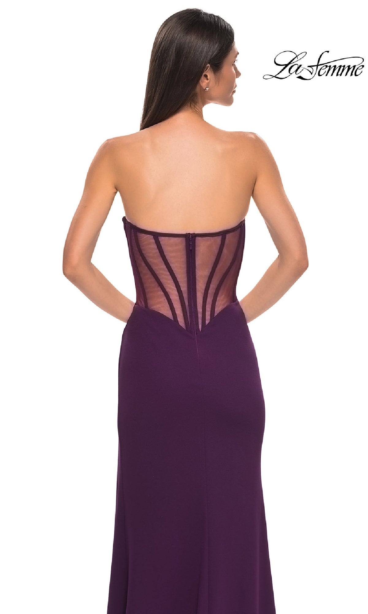 A woman wears the La Femme 32849 Asymmetrical Strapless Prom Gown in purple, featuring a sheer corset back with visible boning, shown from behind. The La Femme prom dress logo is displayed in the top right corner.