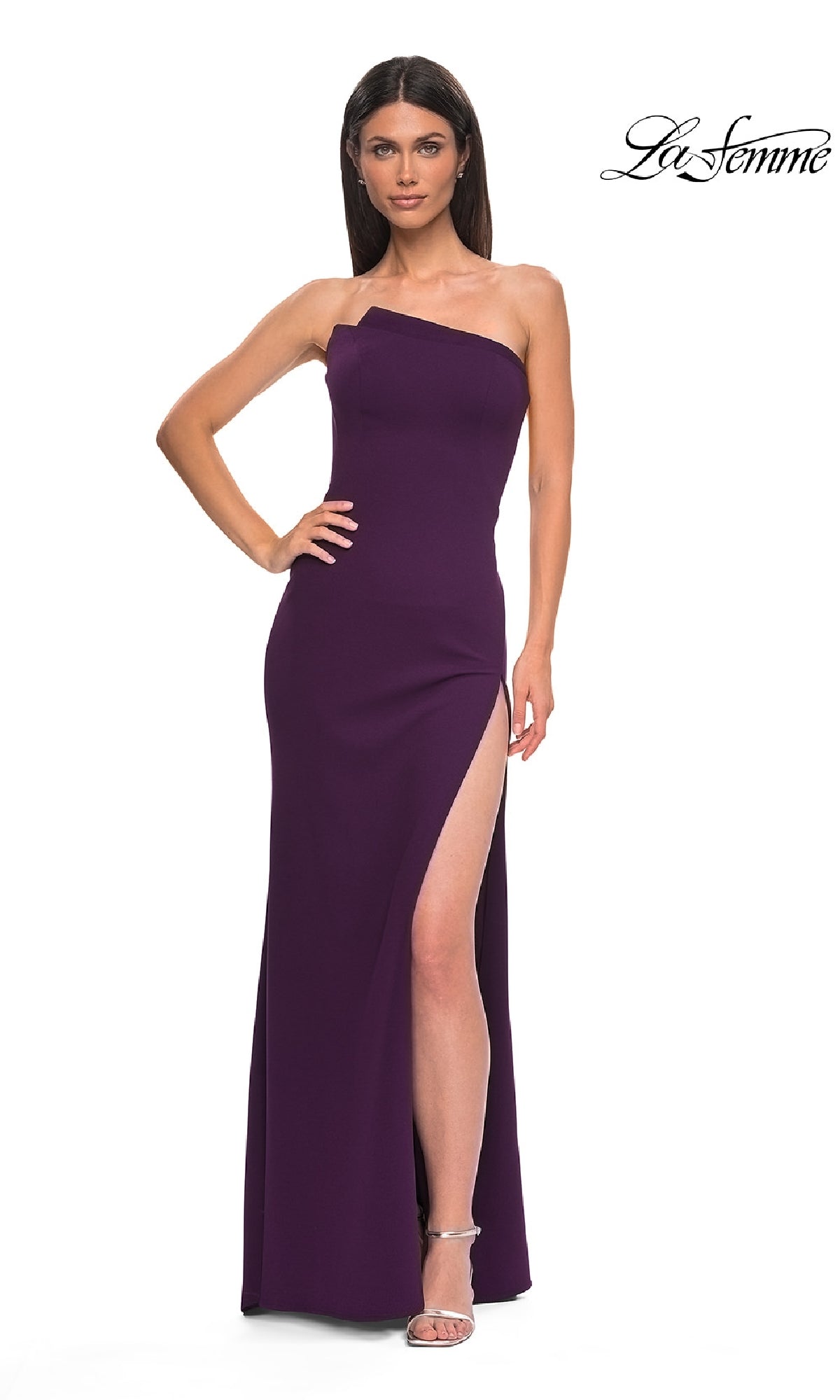 A woman models the La Femme 32849 Asymmetrical Strapless Prom Gown in purple with a high slit, paired with heels, against a white background. The 