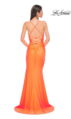 Woman wearing the Strappy-Back Long Prom Dress: La Femme 32851 in bright orange, featuring a floor-length skirt and lace-up strappy-back, standing with her back to the camera.