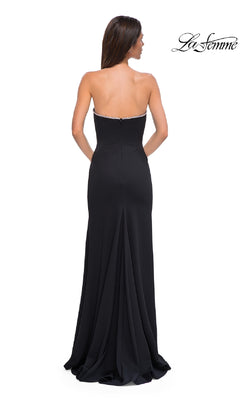 A woman with long brown hair models the Strapless Long Jersey Prom Dress: La Femme 32854, showing its fitted bodice and slight train from the back. The "La Femme" logo appears in the top right corner.