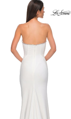 A woman models the Strapless Long Jersey Prom Dress: La Femme 32854 in white, shown from the back with the La Femme logo displayed in the top right corner.