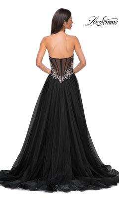 Woman showcasing the La Femme 32862 Beaded-Corset Strapless Prom Gown, featuring a beaded corset back, floral embellishments, and a floor-length tulle skirt, viewed from behind.