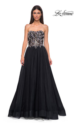 A woman wears the Beaded-Corset Strapless Prom Gown: La Femme 32862, featuring a sheer, floral-embellished bodice and flowing tulle skirt. The "La Femme" logo appears in the upper right corner.
