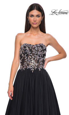 A woman wears the Beaded-Corset Strapless Prom Gown (La Femme 32862), featuring a beaded leaf-pattern corset bodice and flowing tulle a-line skirt. "La Femme" logo appears in the top right corner.