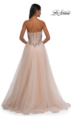 A woman wearing the La Femme 32862 Beaded-Corset Strapless Prom Gown with a fitted bodice stands with her back to the camera.