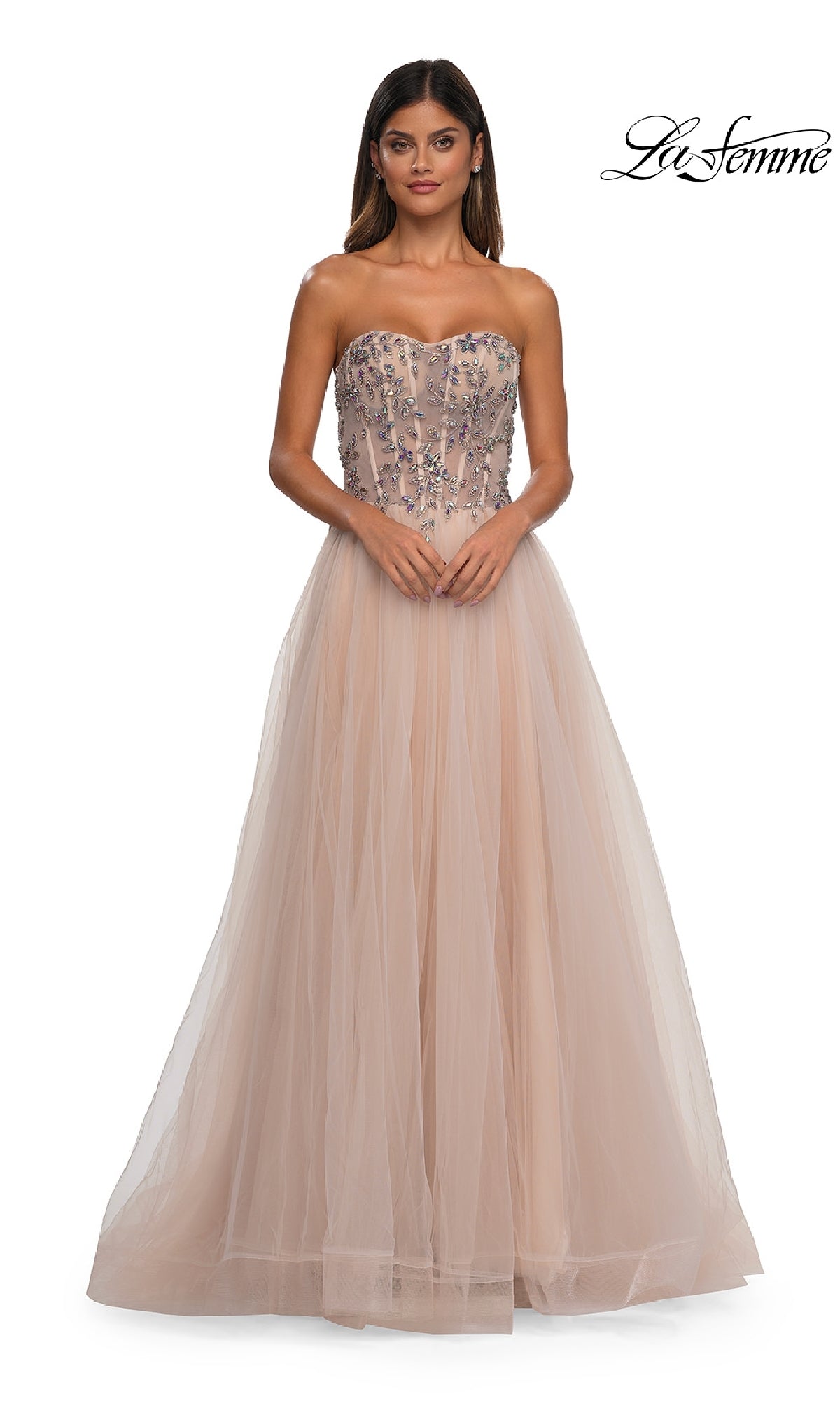 A woman models the Beaded-Corset Strapless Prom Gown: La Femme 32862, featuring a long light beige a-line tulle skirt and beaded corset bodice, against a white background with the 