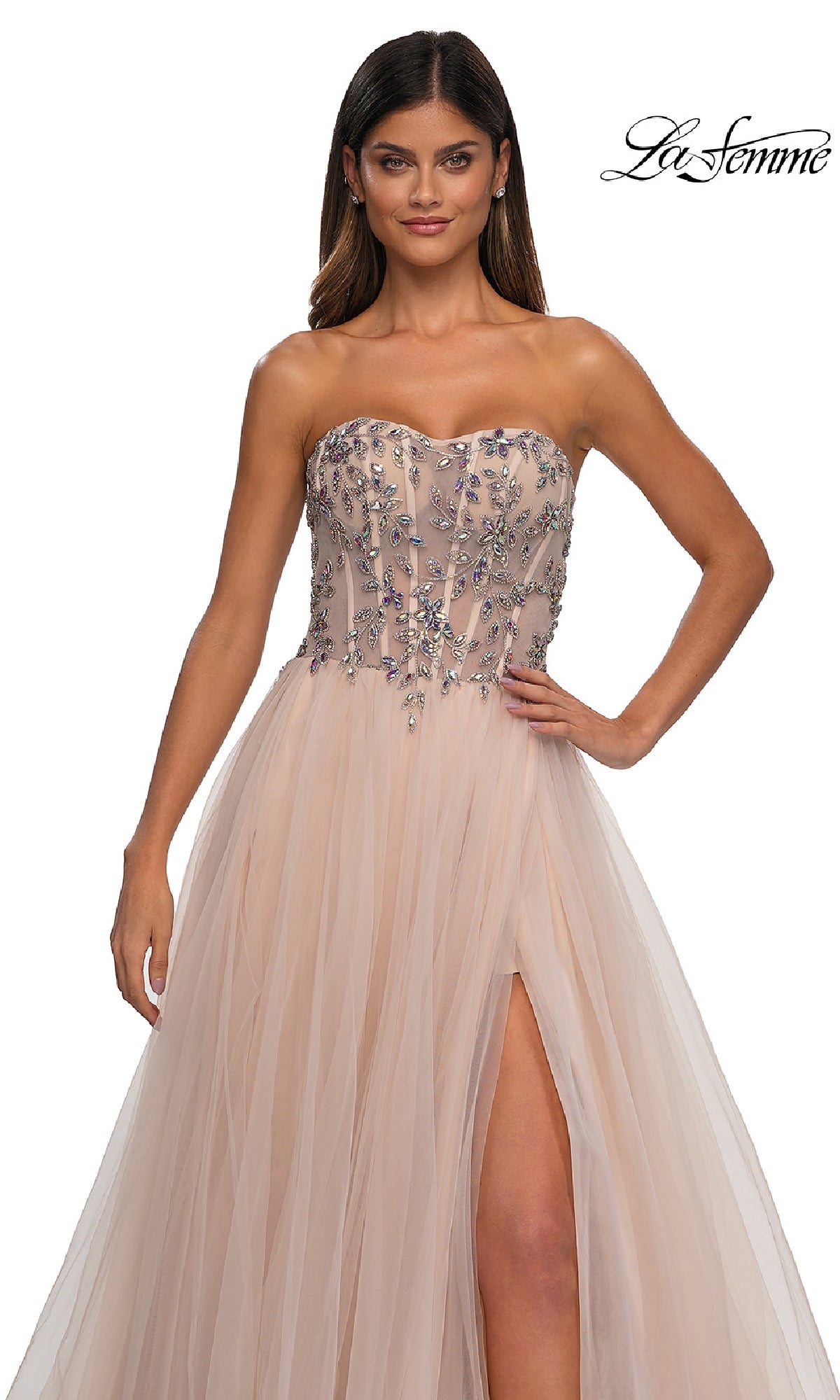 A woman wears the Beaded-Corset Strapless Prom Gown: La Femme 32862, featuring a long a-line silhouette, beaded corset bodice, tulle skirt with thigh-high slit. 