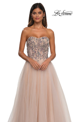 Woman models the La Femme 32862 Beaded-Corset Strapless Prom Gown, featuring a long A-line tulle skirt and sparkling corset bodice; "La Femme" logo appears in the top right corner.