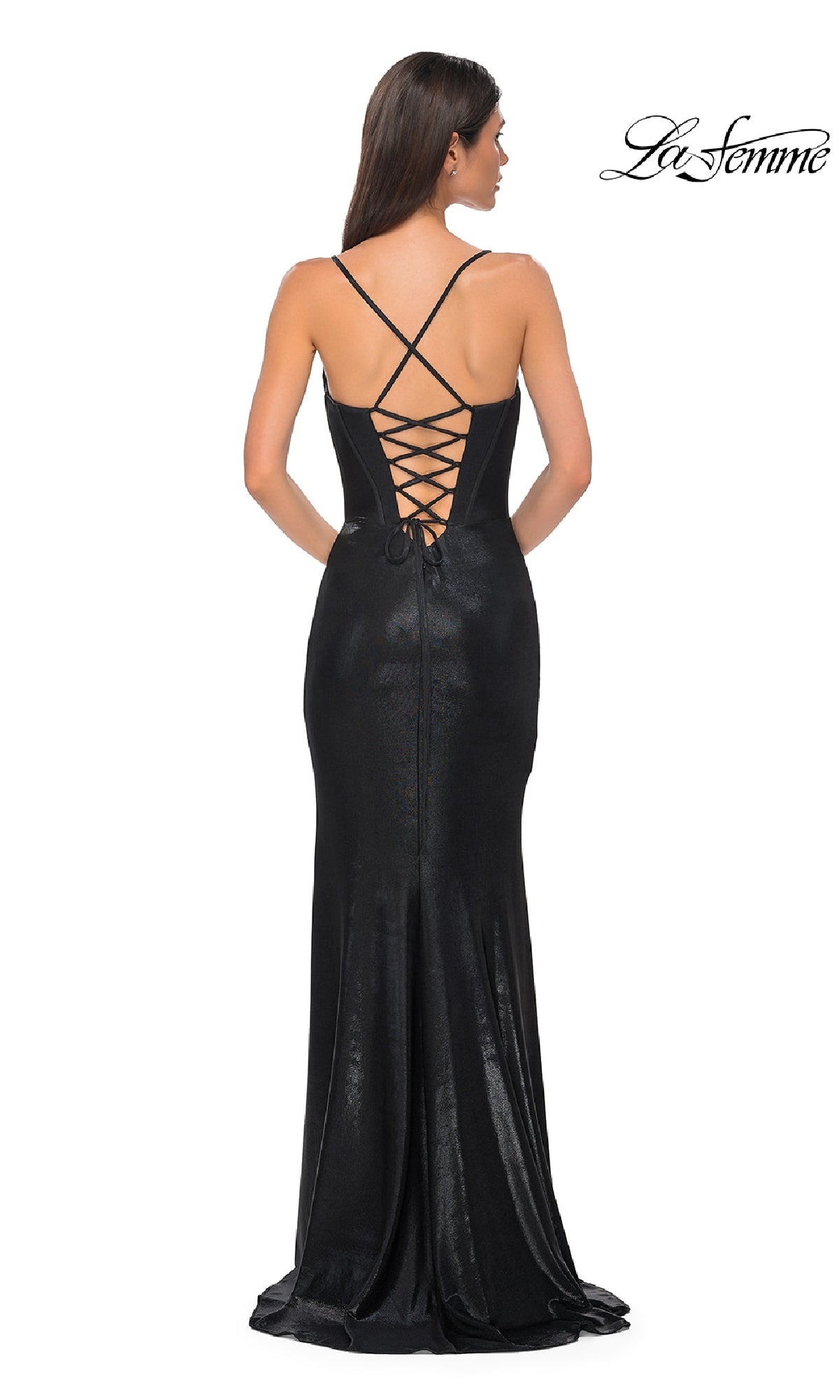 A woman wears the La Femme 32877 Lace-Up Long Metallic Prom Dress, featuring a fitted black silhouette, lace-up back with thin crisscross straps, subtle metallic sheen, and a slight train as she poses with her back to the camera.