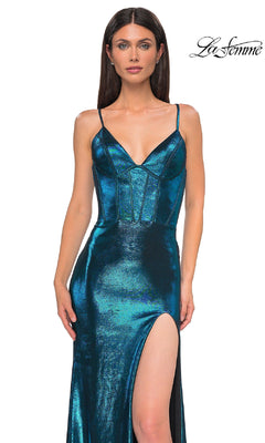 A woman wears the Lace-Up Long Metallic Prom Dress: La Femme 32877, featuring a metallic teal hue, thin straps, structured bodice, and high thigh slit, standing against a white background with the “La Femme” logo in the upper right corner.