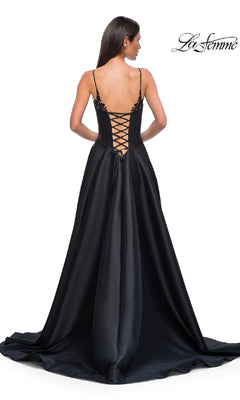 A woman in the Lace-Up Long Mikado Prom Dress (La Femme 32878) stands with her back to the camera, showcasing elegant thin straps and a lace-up detail. "La Femme" logo appears in the top right corner.