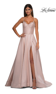 A woman wears the Lace-Up Long Mikado Prom Dress (La Femme 32878) in blush pink, featuring a floor-length A-line silhouette, fitted bodice, thin straps, and high slit, standing against a plain white background.