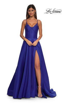 Woman wearing the Lace-Up Long Mikado Prom Dress: La Femme 32878 in royal blue, featuring spaghetti straps, a corset bodice, lace-up back, and high thigh slit against a plain background.