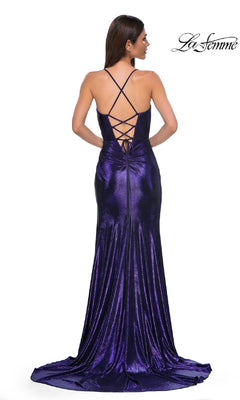 A woman faces away, showcasing the La Femme 32884 Lace-Up Long Metallic Prom Dress, a floor-length purple gown with crisscross back straps and a train. The "La Femme" logo appears in the top right corner.