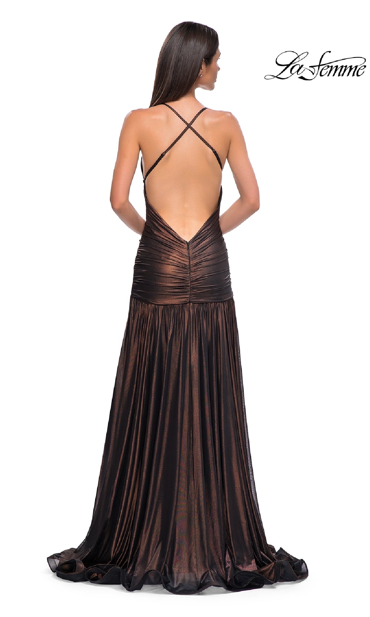 A woman models the La Femme 32887 long prom dress, featuring metallic fabric, an open back, and crisscross straps, as she stands with her back to the camera.