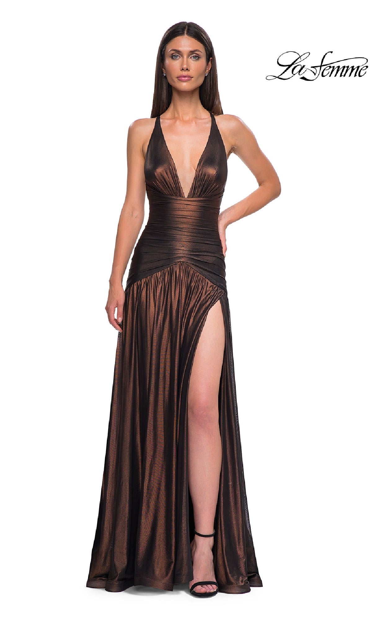 Wearing the Long Prom Dress: La Femme 32887, a woman poses against a white background. The metallic gown features a deep v-neckline, ruched waist, high slit, and spaghetti straps, with the “La Femme” logo in the corner.