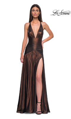 Wearing the Long Prom Dress: La Femme 32887, a woman poses against a white background. The metallic gown features a deep v-neckline, ruched waist, high slit, and spaghetti straps, with the “La Femme” logo in the corner.
