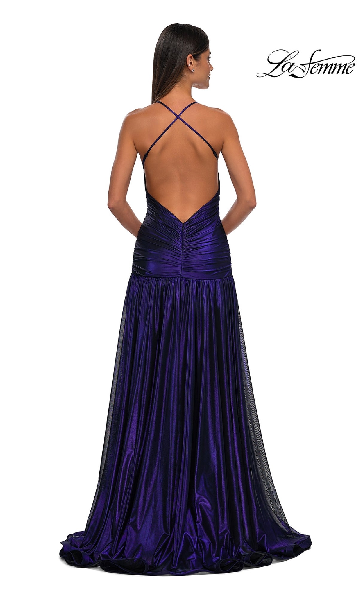 A woman stands with her back to the camera in the La Femme 32887 long prom dress, a floor-length deep purple gown featuring an open back and crisscross straps.