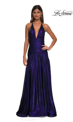 A woman wearing the La Femme 32887 long prom dress—sleeveless, deep v-neckline, floor-length metallic purple with ruched bodice—stands against a plain white background. "La Femme" logo appears in the top right corner.