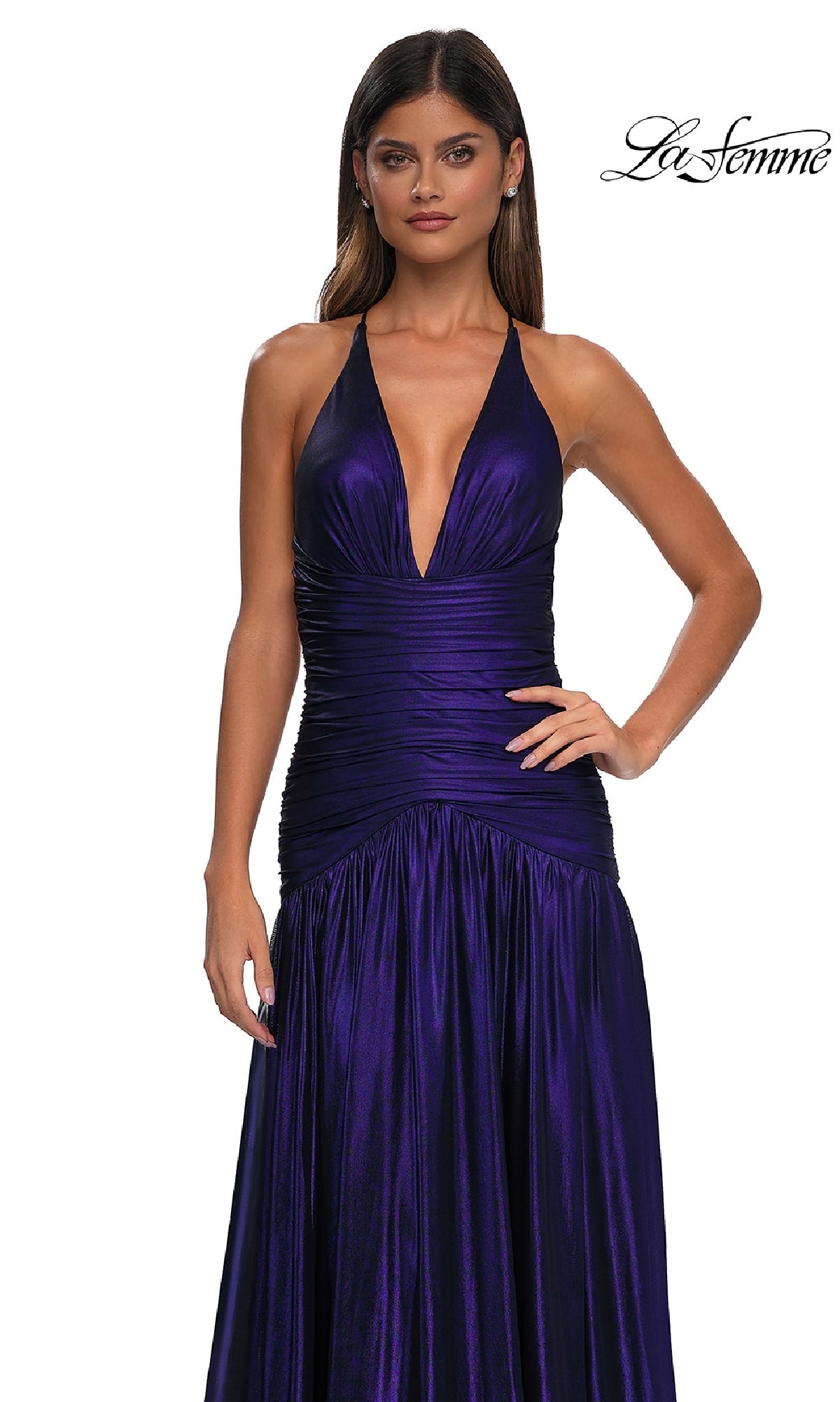 A woman models the La Femme 32887, a deep purple halter-neck floor-length prom dress with a fitted ruched bodice and open back, photographed against a white background.