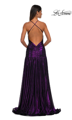 Woman models the La Femme 32887 long prom dress—a shiny, floor-length purple metallic gown featuring crisscross straps and an open back. The "La Femme" logo is displayed in the top right corner.