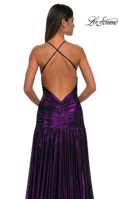 A woman faces away in the La Femme 32887 long prom dress, featuring a metallic finish, crisscross open back, ruched waist, and flowing skirt. The "La Femme" logo appears in the top right corner.