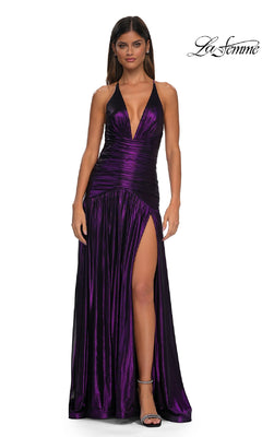 A woman models the La Femme 32887 long prom dress, featuring a sleeveless deep purple metallic design with a deep v-neckline and high slit, standing against a white background. The La Femme logo appears in the top right corner.
