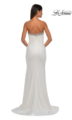 Woman in the Bead-Trimmed Long Prom Dress: La Femme 32891. This strapless, floor-length formal dress features jeweled trim at the top, a fitted silhouette, a slight train, and is shown from the back for an elegant look.