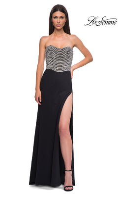 A woman models the Strapless Long Black Prom Dress: La Femme 32910, featuring a beaded bodice and high side slit, against a white background.