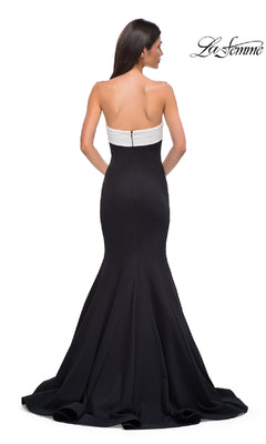 A woman models the La Femme 32914 strapless long black prom dress, facing away to display its fitted bodice and flared mermaid skirt. The "La Femme" logo appears in the top right corner.