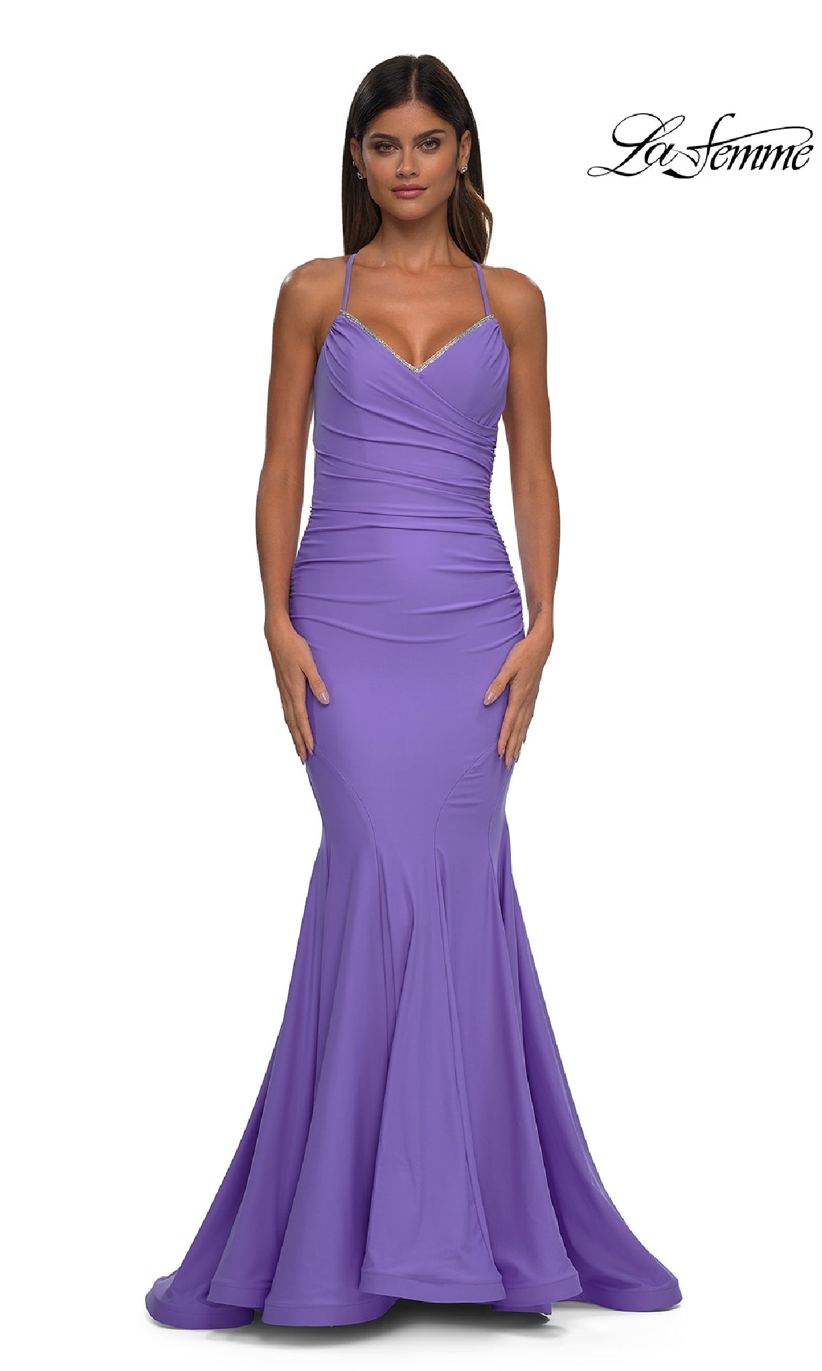 A woman wears the Elegant Long Mermaid Prom Dress: La Femme 32918—a fitted, floor-length lavender gown with thin straps and a slight flare; the 