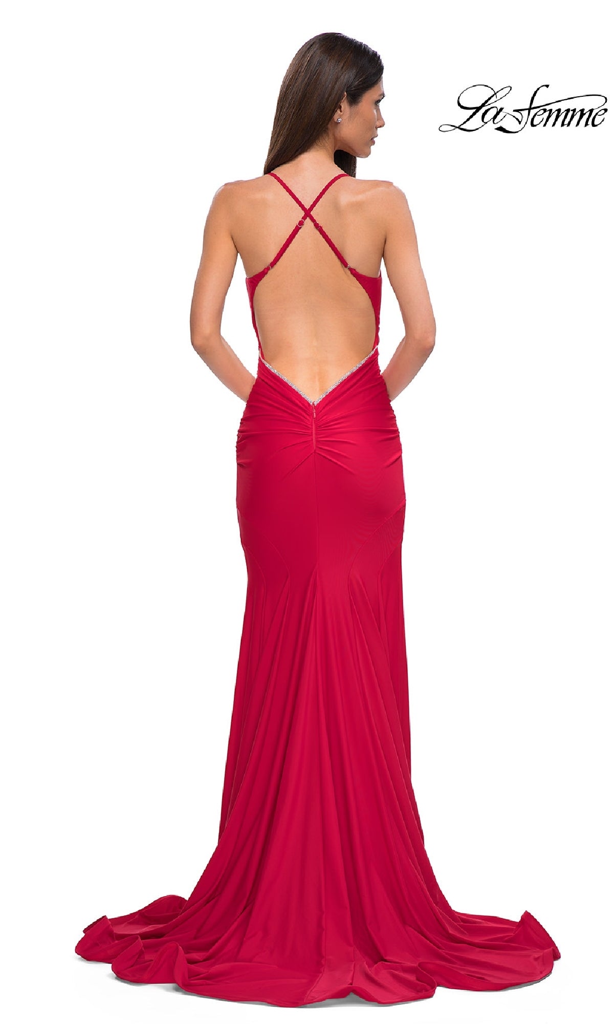 A woman faces away, wearing the Elegant Long Mermaid Prom Dress: La Femme 32918—a floor-length, open-back gown with crisscross straps, a fitted mermaid silhouette, and slight train. 
