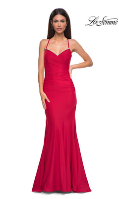 A woman models the Elegant Long Mermaid Prom Dress: La Femme 32918, a fitted, floor-length red gown with spaghetti straps and subtle ruching, posing against a white background with the "La Femme" logo in the top right.
