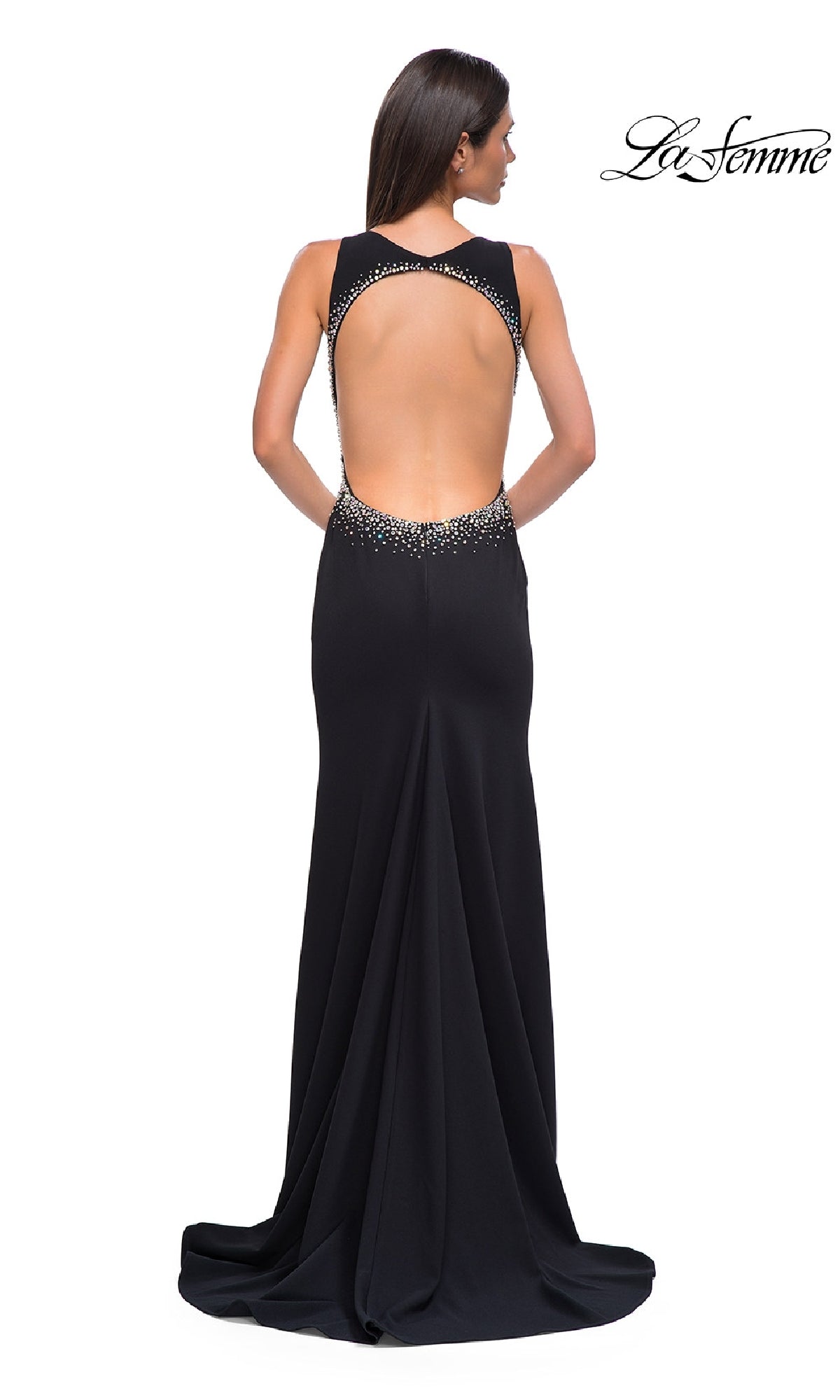 A woman stands with her back to the camera in the La Femme 32922 long black jersey prom dress, featuring an open back and rhinestone details. The 